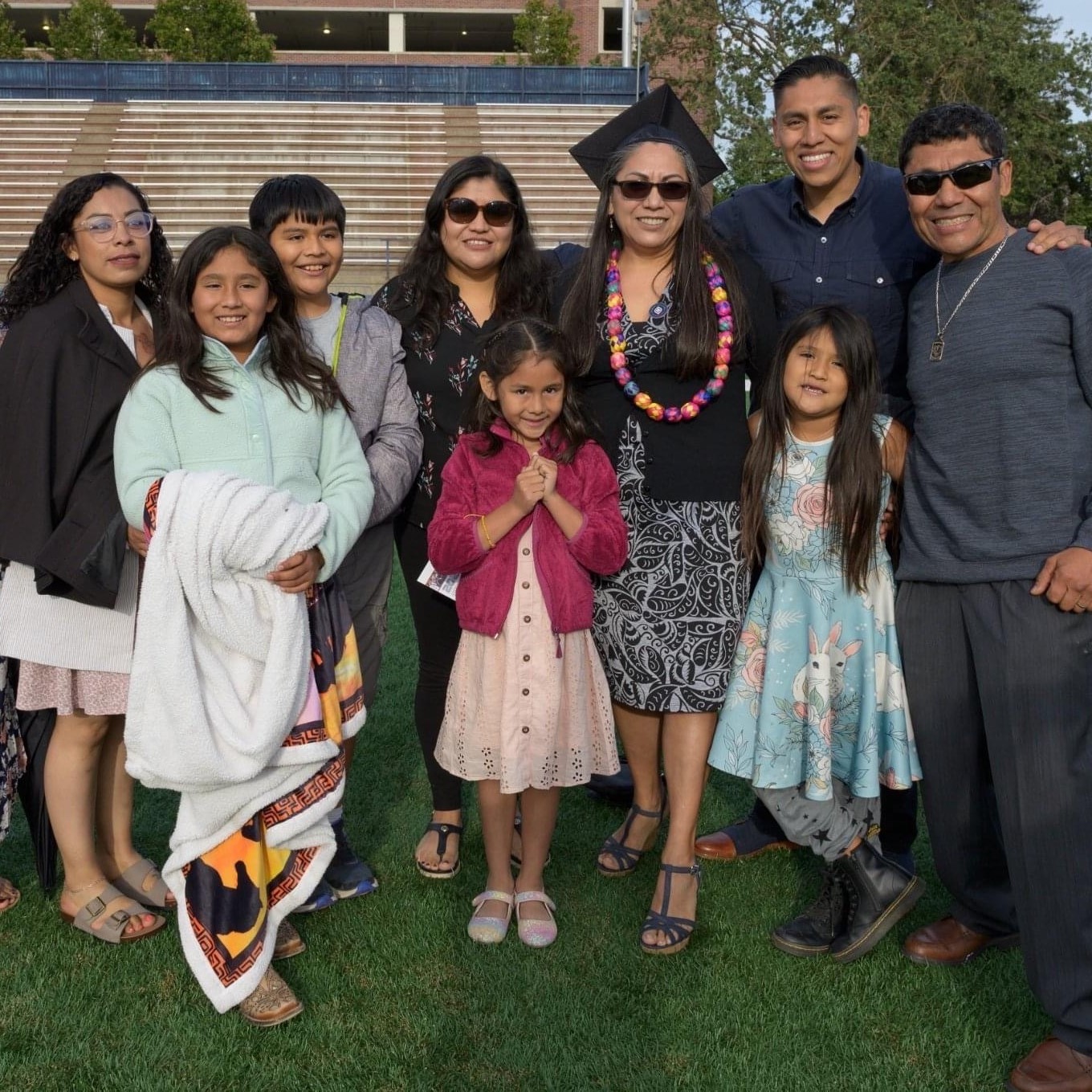 A student celebrating her accomplishments with her family.